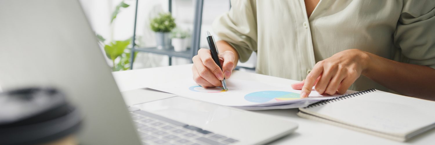 Freelance young Asia businesswoman casual wear using laptop work Freelance young Asia businesswoman casual wear using laptop working in living room at home. Working from home, remotely work, self isolation, social distancing, quarantine for corona virus prevention.
